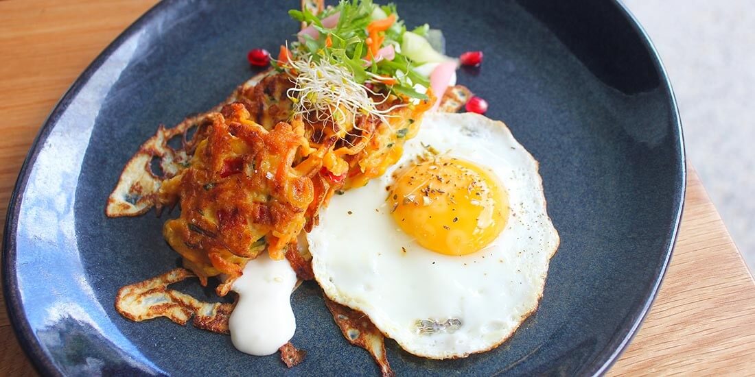 Sweet potato rostie with lightly picked vegetables topped with fried egg
