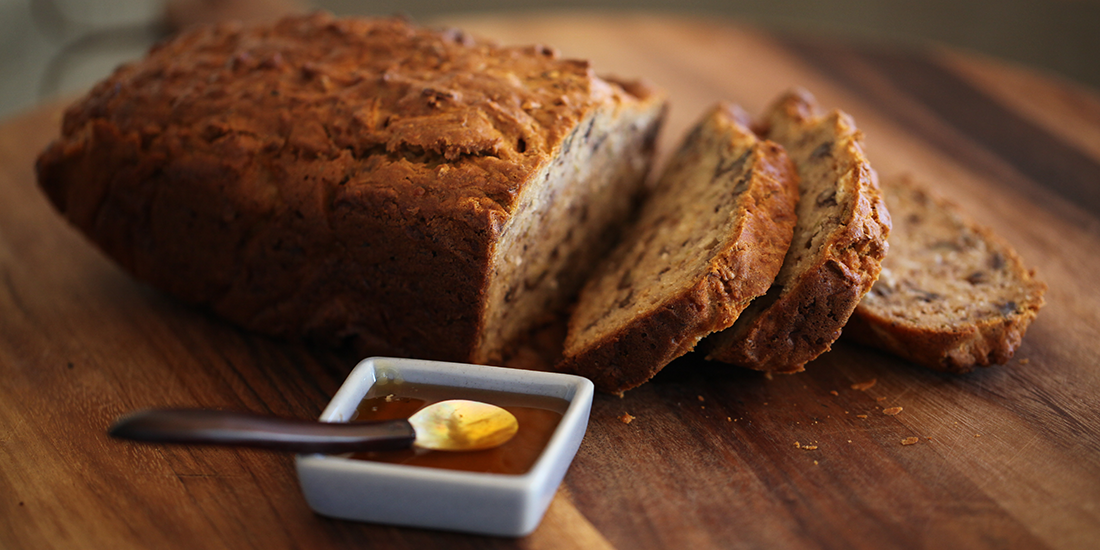 Bite into freshly baked apple, cinnamon, coconut and walnut loaf