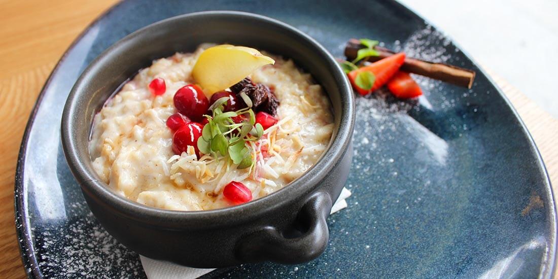 Toasted coconut breakfast porridge with cranberry and orange compote