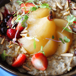 Power seed almond milk porridge with toasted nuts, vanilla poached pear and berries