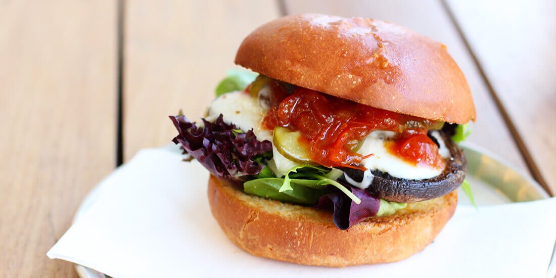 Make My Day mushroom burger with smoked mozzarella, butter pickle, relish and greens