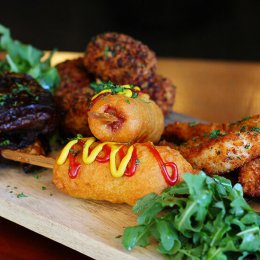 Share board with chicken tenders, baby pork ribs, corn dogs, mac and cheese croquettes and calamari