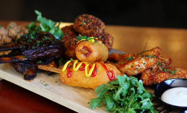 Share board with chicken tenders, baby pork ribs, corn dogs, mac and cheese croquettes and calamari