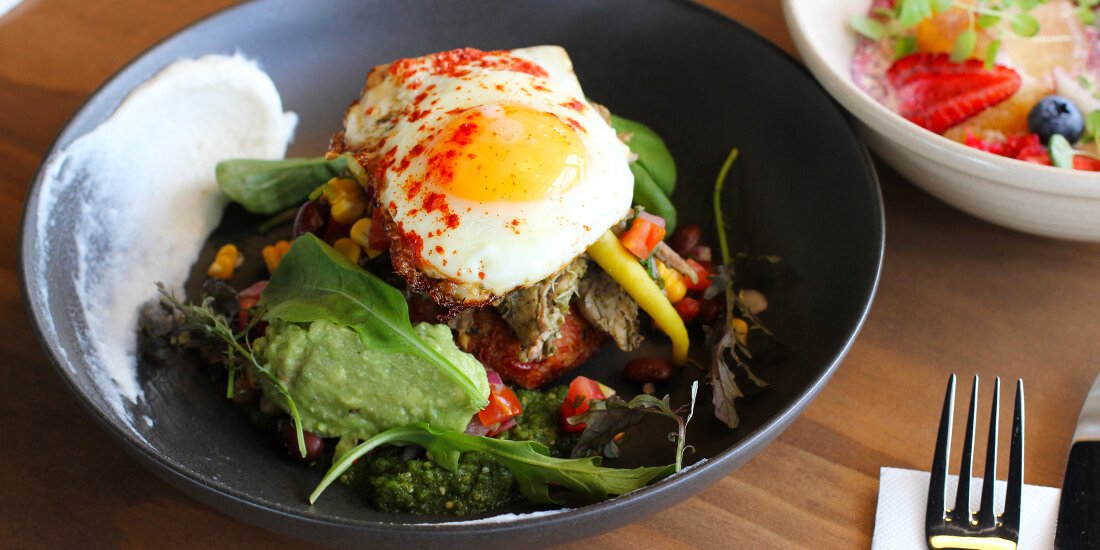 Pablo Diabolo with haloumi, potato, sour cream and chive hash cake, slow-roasted pork, avocade, spiced fried eggs and green mole