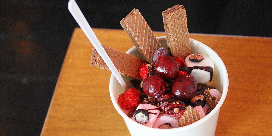 Winner Winner's sundae with vanilla wafers, crushed peanuts, whipped Chantilly cream, and cherries