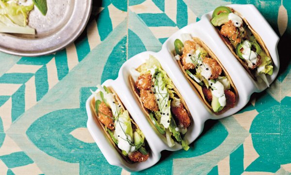 Munch on sesame crunch chicken tacos with cos, avocado and zesty crema