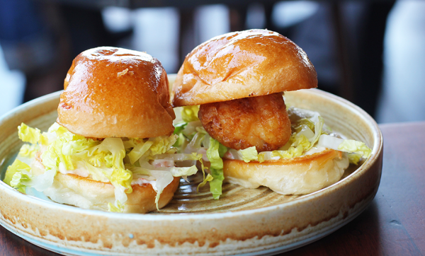 Battered prawn rolls, lettuce and sriracha prawn mayonnaise on a toasted milk bun