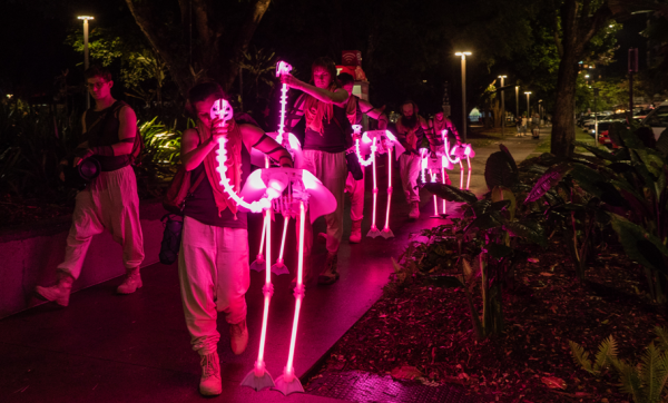 Witness a playful parade of fluorescent flamingos as they light up West Village this September