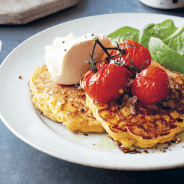 Snack on corn fritters with roast tomatoes and smashed avocado