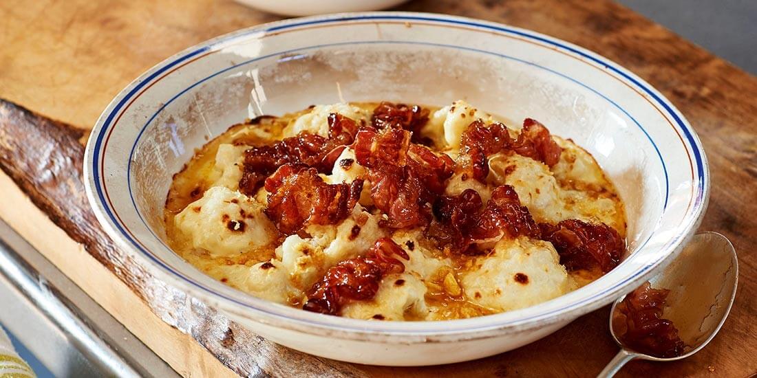 Warm up with hearty cauliflower cheese with crispy maple syrup pancetta